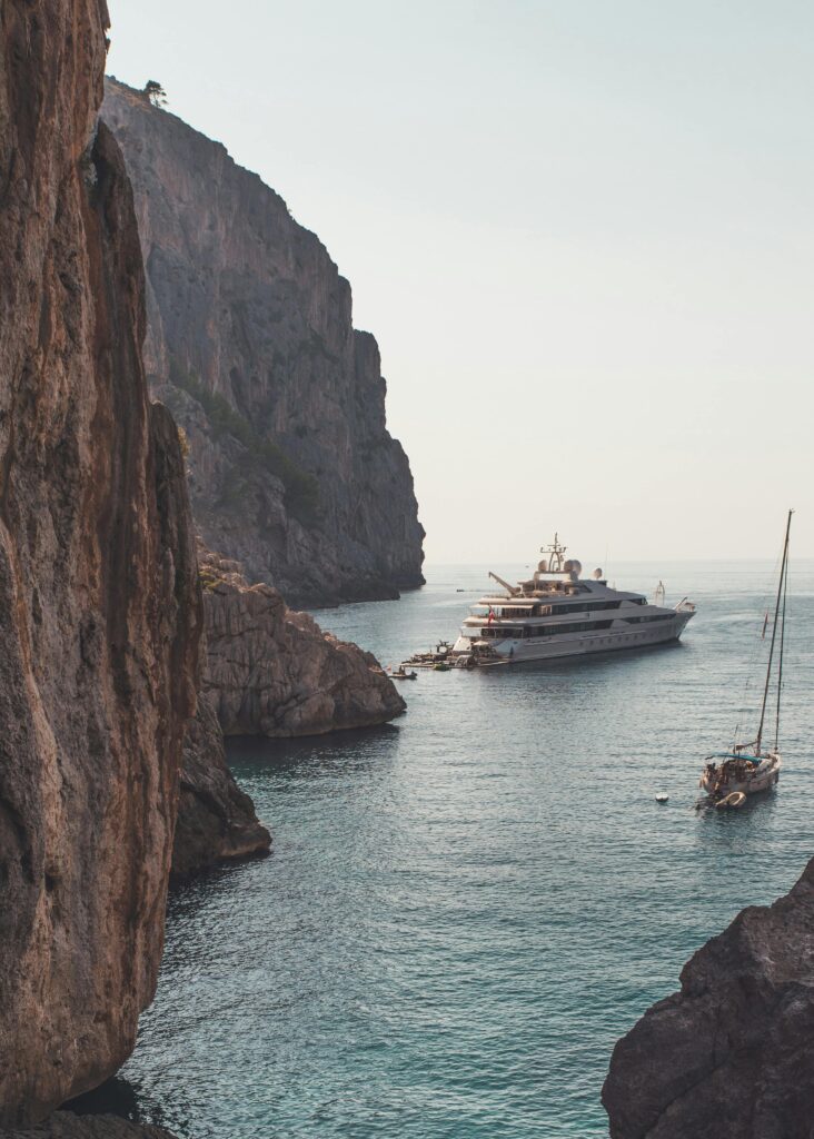 Luxury yacht anchored amidst the stunning cliffs of Escorca, Palma de Mallorca. Perfect vacation escape.